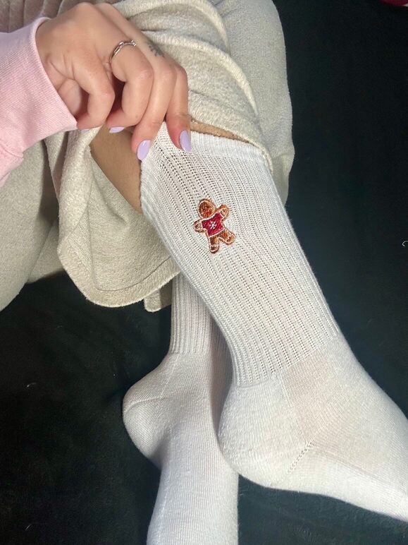 Chaussettes blanches hautes, 100% coton. Personnalisation des chaussettes grâce à des broderies. Il faut choisir parmi un choix de broderies dessinées à la main sur le thème de l’hiver, Noël, fêtes fin d’année, winter. La broderie est présente sur le côté extérieur des chaussettes. Toutes les broderies sont faites à la commande selon la personnalisation choisie. Ici, il s’agit de la broderie bonhomme en pain d'épices