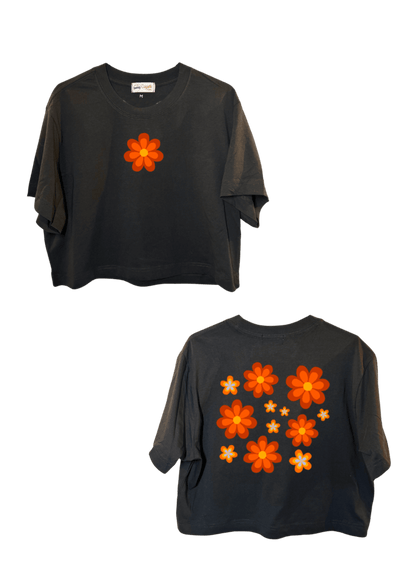 Crop top blanc court, manche courte, 100% coton. Personnalisation du crop top grâce à une technique de flocage, le DTF, pour une meilleure qualité d’impression et de tenue. La personnalisation est floquée à l’avant au niveau du cœur, en haut à gauche et à l’arrière en grand dans le dos. Ici, il s’agit de la personnalisation de DTF fleur orange style seventies 70. 