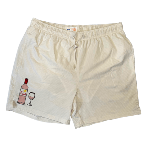 Maillot de plage pour homme couleur beige. Personnalisation du maillot grâce à des broderies. Il faut choisir parmi un choix de broderies dessinées à la main sur le thème de l’été sur la Côte d’Azur dans les Alpes Maritimes, 06. La broderie est brodée sur l’avant du maillot, jambe droite. Toutes les broderies sont faites à la commande selon la personnalisation choisie. Ici, il s’agit de la broderie bouteille de vin rosé et verre de vin rosé.